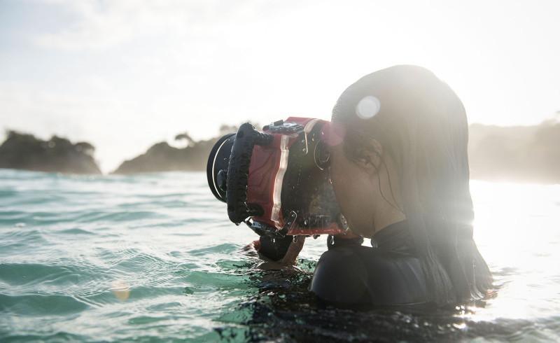 Photographer in the water with the new AquaTech BASE water housing kit