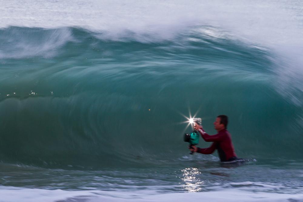 Stan Moniz photographing a wave with AquaTech gear